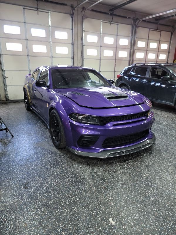 Purple widebody Dodge Charger in the work bay
